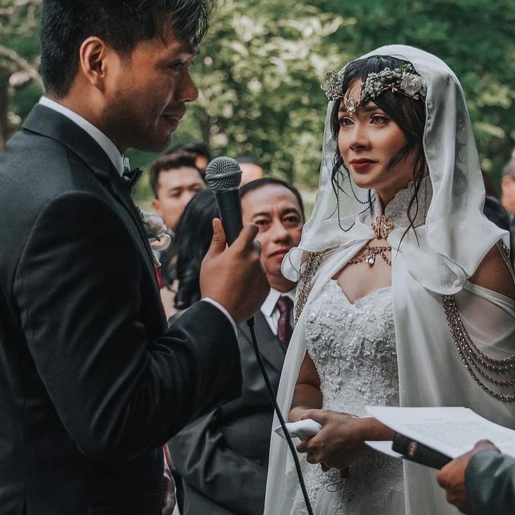 a bride and groom are exchanging vows at their wedding