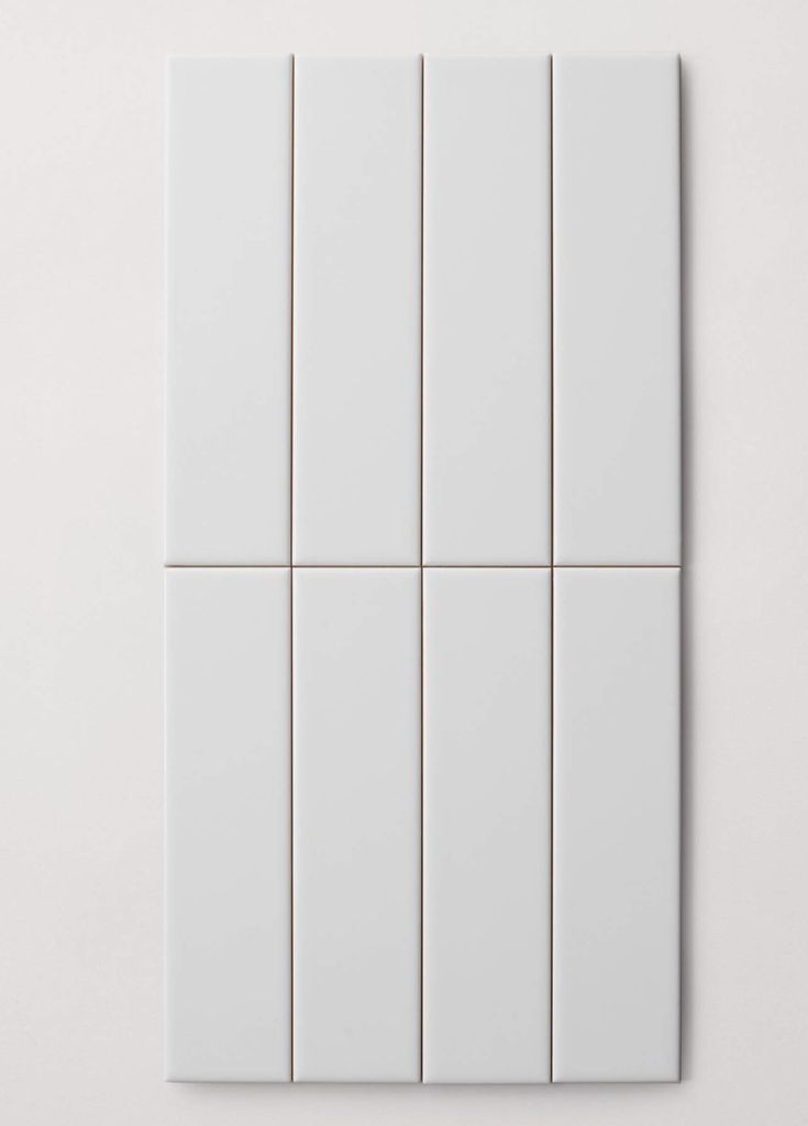 several white tiles are arranged on the wall