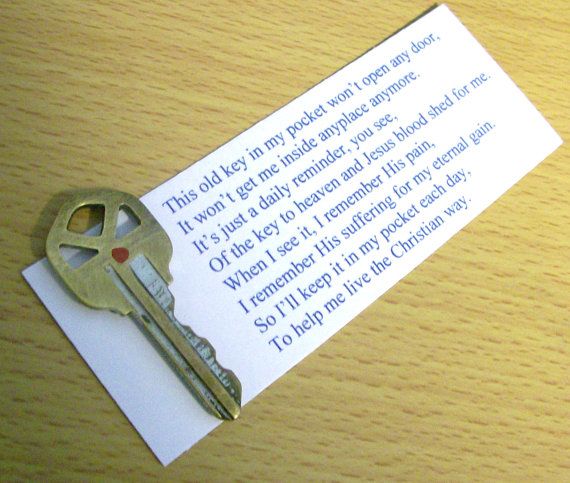 a piece of paper with a key attached to it on top of a wooden table