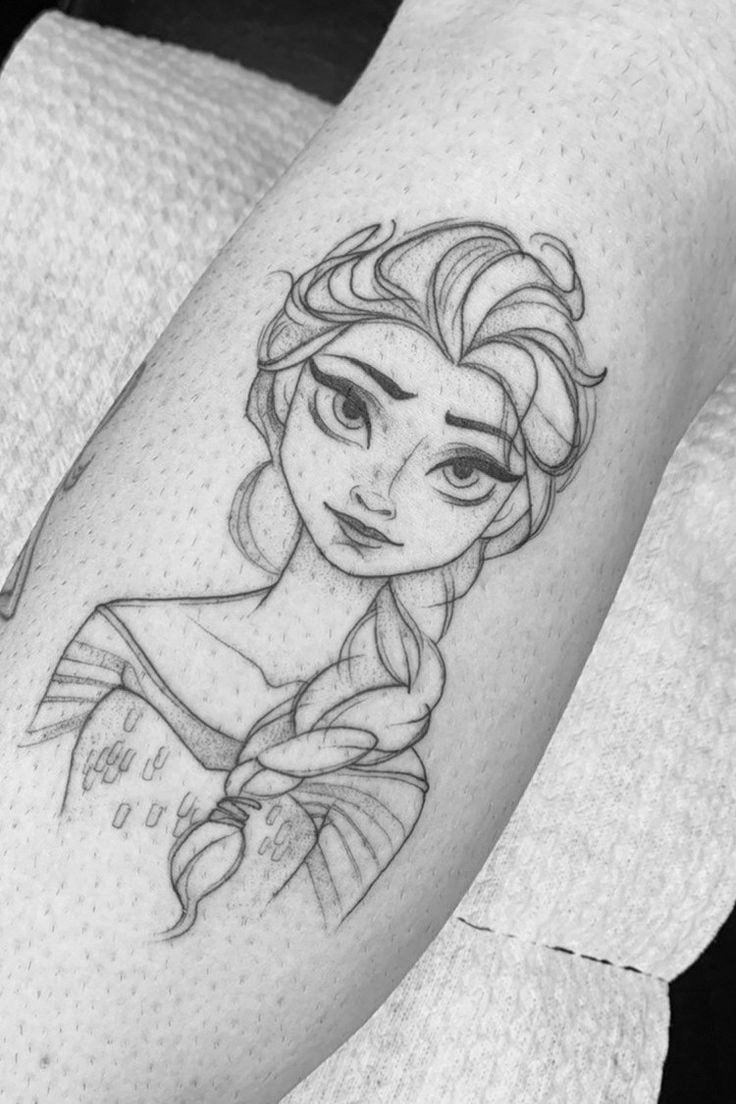 a woman's leg with a disney character tattoo on it