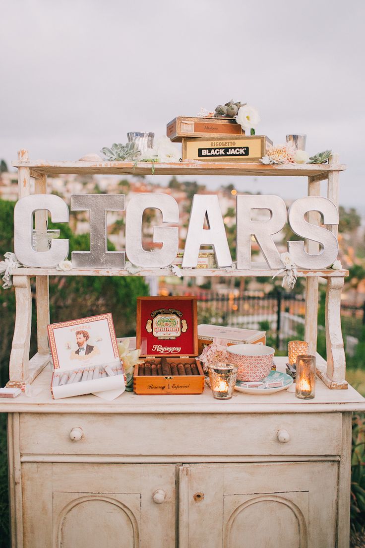 an old dresser is decorated with vintage signs and other items that are sitting on top of it