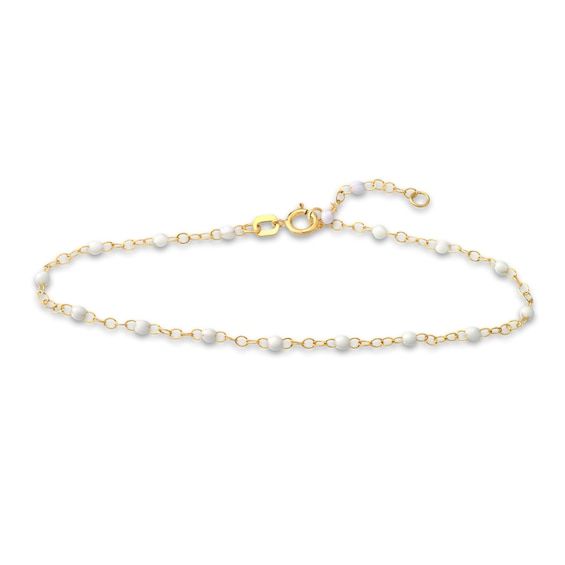 Distinctive white enamel beads embellish shimmering links around the length of this stylish women's bracelet. Fashioned in 14K yellow gold, the 7.5-inch cable chain secures in place with a spring ring clasp. White Gold Beaded Chain Jewelry, Elegant White Beaded Bracelets With Adjustable Chain, Classic White Chain Bracelet For Everyday, Dainty White 14k Gold Chain Bracelet, Elegant White Beaded Bracelet With Adjustable Chain, Delicate White Chain Bracelet With Pearls, Elegant White Chain Bracelet For Everyday, Delicate White 14k Gold Bracelet, Delicate White Pearl Chain Bracelet