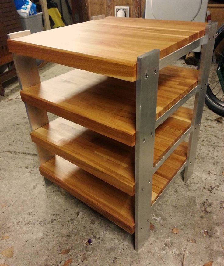 a wooden shelf with metal legs in a garage