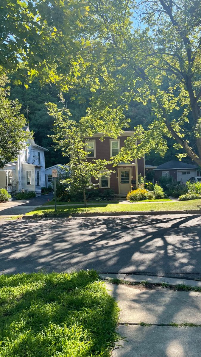 a stop sign on the corner of a residential street