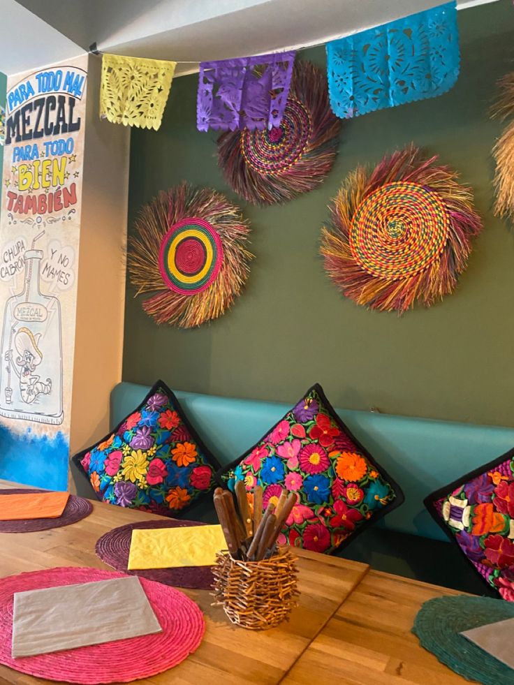 colorful pillows and other decorative items are on the table