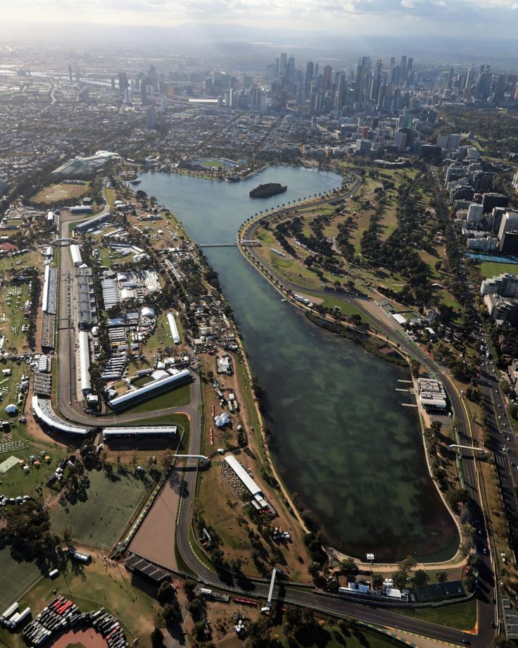 an aerial view of the city and river with buildings on both sides, in australia