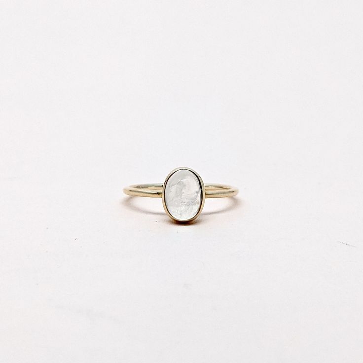 Natural Rainbow Moonstone Oval Cabochon Gemstone Stackable Ring. Semi Precious Gemstone Ring in 14k SOLID GOLD For Her from our Capsule Jewelry Collection.RainBow Moonstone is set in Bezel Setting in our Factory. Gold Ring AAA+ Quality. Perfect Gift For Everyday or June Birthstone Gift for Your Loved Ones. ►  DIMENSIONS : ◆ Gemstone : Rainbow Moonstone 0.60ct ◆ Stone size : 6*8 mm ◆ Shank Width : 1 mm      ◆  Material :  14k Yellow Gold      EACH Ring is Stamped With 585 Marked As 14k GOLD International Standard. All my gemstones are hand-selected for best quality assurance, then precisely sawed, and shaped into the desired geometry. The precious stones are then delicately grinned, sanded, and hand-polished to make sure each Ring has the perfect aesthetic. * Contact us For Resizing and Per Oval Gemstone Gold Stackable Rings, Gold Oval Stackable Rings For Promise, Gold Oval Stackable Promise Rings, Gold Stackable Promise Rings, Timeless Round Moonstone Ring Gift, Timeless Round Moonstone Ring As Gift, Heirloom Jewelry With Bezel Setting In Recycled Gold, Heirloom Moonstone Ring With Rose Cut Diamonds For Promise, 14k Gold White Jewelry With Si Clarity