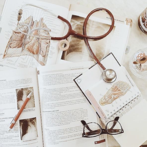 an open book with eye glasses on top of it next to a pair of reading glasses