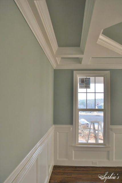 an empty room with wooden floors and white trim