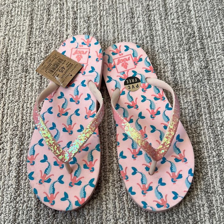 Open Toe Slip On Style Perfect For Water Mermaid Print On Sole Synthetic Sole These Run Small, Size Up Kids 4/5 Pink Synthetic Beach Slippers, Pink Synthetic Slippers For The Beach, Pink Vacation Slippers With Cushioned Footbed, Pink Non-slip Slippers For Vacation, Pink Cushioned Slippers For Vacation, Playful Synthetic Flip Flops For Beach, Pink Non-slip Open Toe Flip Flops, Pink Flat Synthetic Flip Flops, Pink Cushioned Flip Flops For The Beach