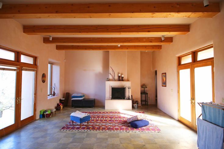 a living room filled with furniture and lots of windows