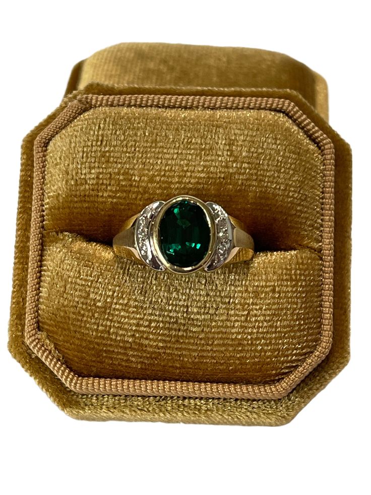 "Beautiful modern 14k yellow gold created emerald & genuine diamond ring! This stunning ring features an oval faceted 1.41 carat created emerald, that is securely bezel set. There are six genuine diamonds along the sides in white gold. A timeless piece of fine modern jewelry, featuring May's birthstone!  ERA - Circa 1990's METAL / MATERIAL - 14k yellow gold, created emerald (approx. 1.41 CT), 6 genuine diamonds (approx. 0.18 CTW) MARKINGS / HISTORY - Inside of band is marked \"14K\" EG CONDITION Smaragd Ring, 4 May, Green Emerald Ring, Sterling Silver Rings Turquoise, Turquoise Ring Silver, May Birthstone, Gold Plated Rings, Emerald Diamond, Metal Material