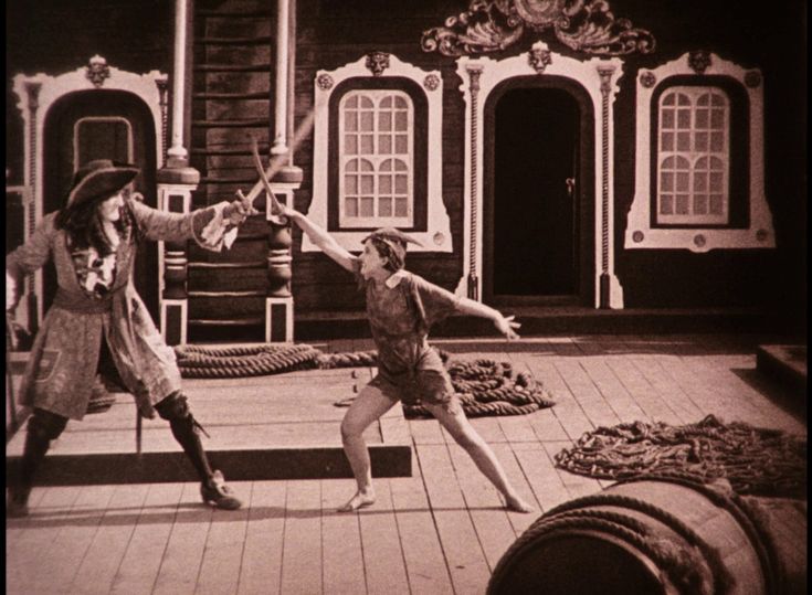 two people are dancing on the deck of a house