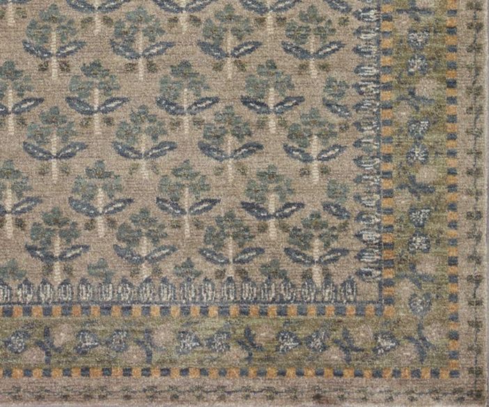 an old rug with blue and green designs on it