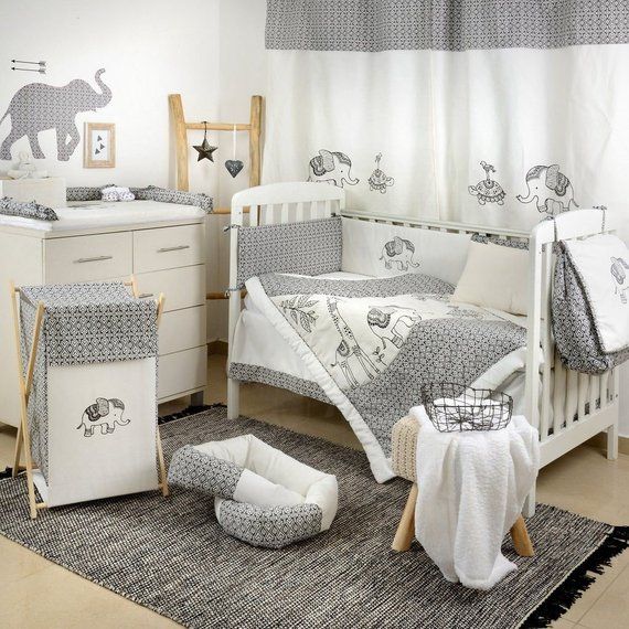 a baby's room with grey and white decor