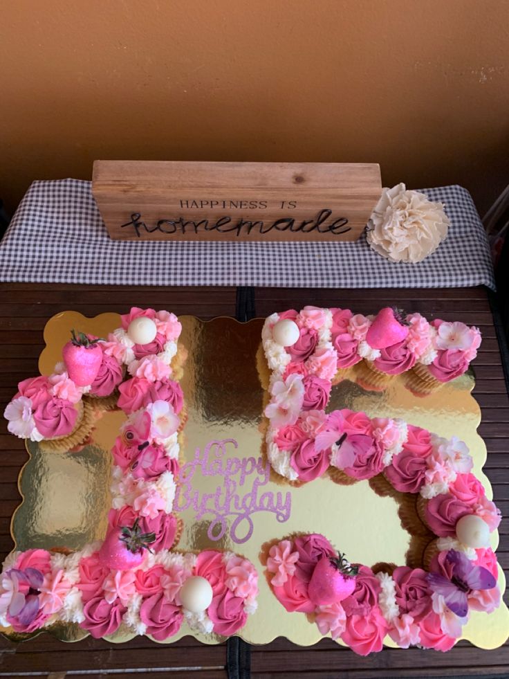 a birthday cake decorated with pink flowers and the number 50