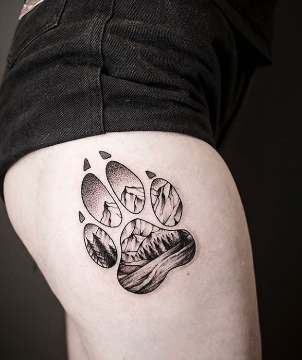 a dog paw tattoo on the right thigh