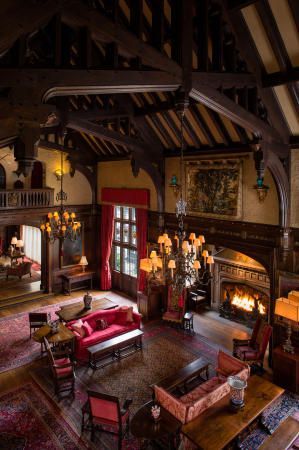 a living room filled with furniture and a fire place in the middle of an open floor plan