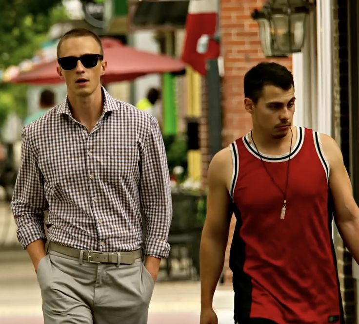 two men are walking down the street together