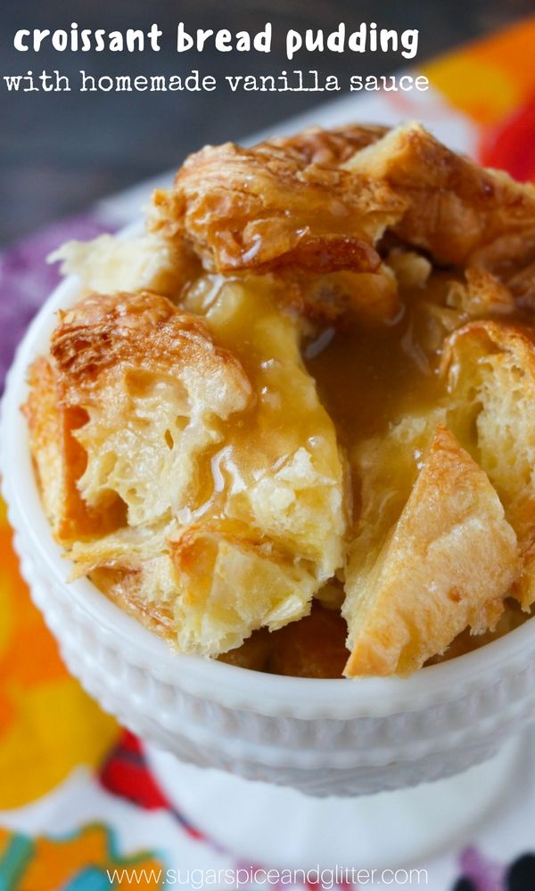 croissant bread pudding with homemade vanilla sauce in a white bowl on a colorful tablecloth