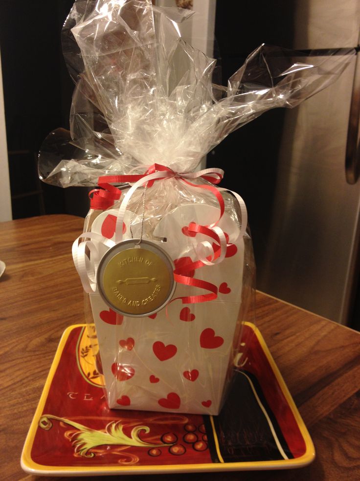 a small gift box with a coin in it on a tray next to a refrigerator