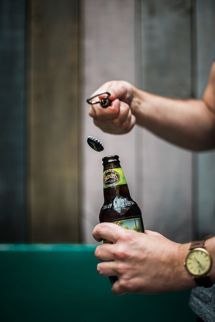 a person holding a beer in their hand