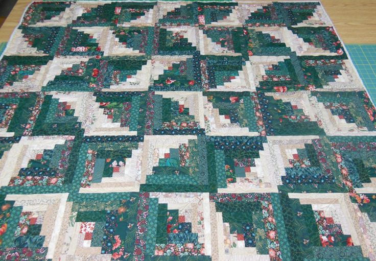 a green and white quilt on a table