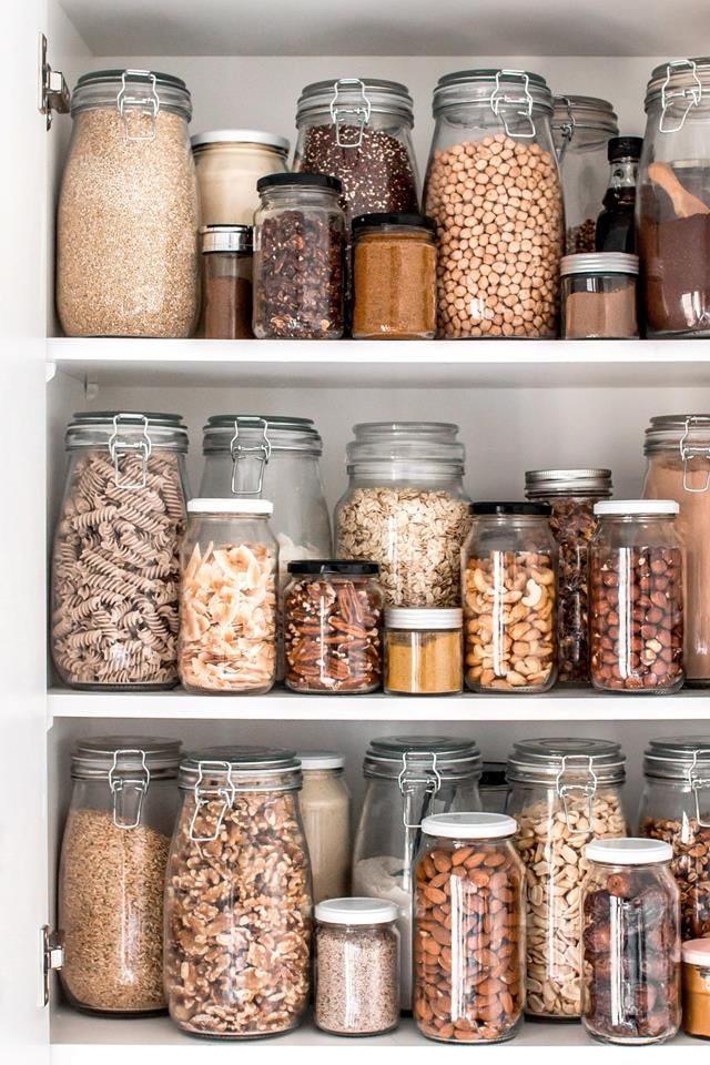 an organized pantry filled with lots of different types of food and spices in glass jars