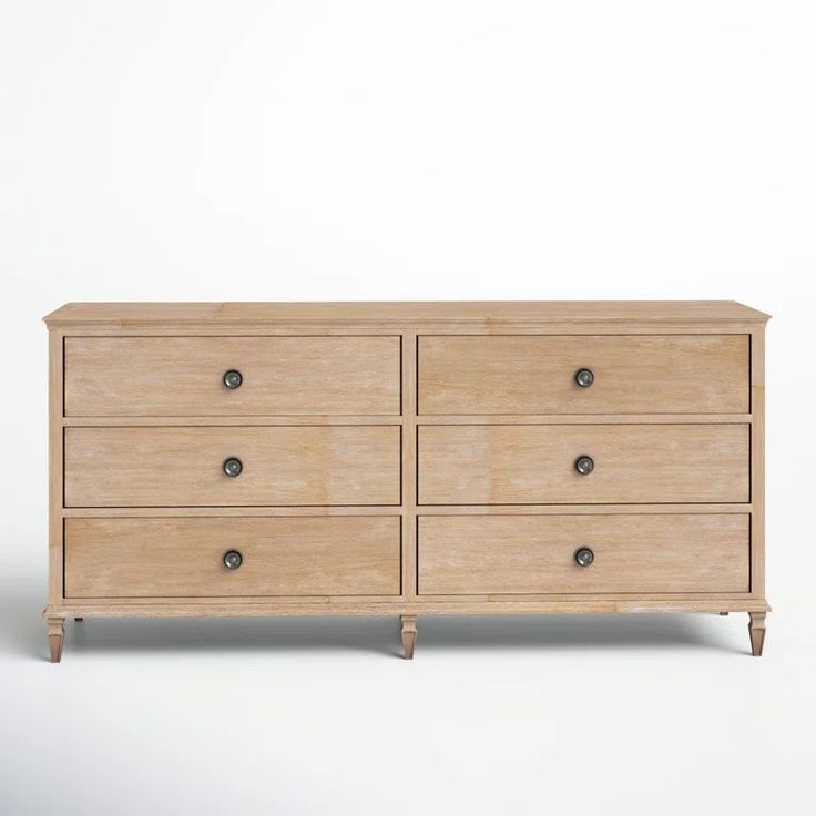 a wooden dresser sitting on top of a white floor