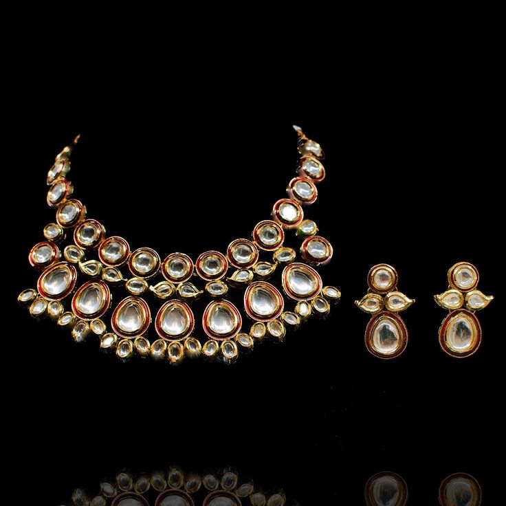 A dreamy set merging traditional with contemporary! Exude glamour in this trendy set encrusted with kundan stones over an enameled base. The look includes necklace and a pair of matching earrings. Approximate earrings length is 1.5". Gold-plated on high-quality brass as base metal. Made by order. Kindly allow 4-6 weeks for the delivery of this item. For custom or urgent requests, please contact support@alacouture.com. *Please Note: We use faux stones and beads in all of our jewelry. Dual-tone Kundan Temple Jewelry Sets, Bollywood Style Festive Jewelry Sets For Designer Wear, Festive Bollywood Designer Jewelry Sets, Gold Kundan Necklace For Designer Wear, Gold Sets With Meenakari For Designer Wear, Gold Sets With Meenakari Detailing, Elegant Kundan Jewelry Sets In Dual-tone, Elegant Dual-tone Kundan Jewelry Sets, Formal Kundan Necklace With Matching Earrings