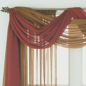 an open window with sheer curtains in front of it