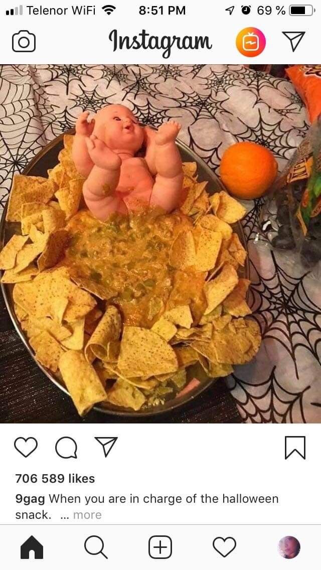 a plate full of tortilla chips and two little pigs sitting on top of them