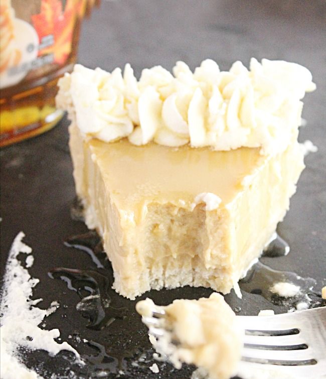 a piece of cake with white frosting on top and a fork next to it