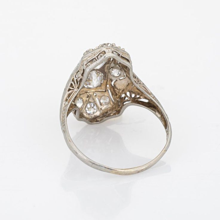 Elegant & finely detailed Belais Art Deco era ring (circa 1920s to 1930s) crafted in 14k white gold.   Two centrally mounted old European cut diamonds are estimated at 0.48 carats each. A further 8 old mine cut diamonds total an estimated 0.42 carats. The total diamond weight is estimated at 1.38 carats (I-J colour and VS2-I2 clarity).      Belais Brothers is a highly regarded and very collectible maker from the late 19th century to the early 20th century. The ring epitomises vintage charm and w Antique Style Brilliant Cut Diamond Ring Collectible, Vintage White Gold Cluster Ring With Rose Cut Diamonds, Silver Estate Diamond Ring For Anniversary, Estate Silver Diamond Ring For Anniversary, Estate Style Silver Diamond Ring For Anniversary, Antique Filigree Platinum Ring In Diamond White, Antique Platinum Filigree Ring In Diamond White, Antique Platinum Diamond Ring With Diamond Accents, Collectible Round Diamond Ring With Intricate Design