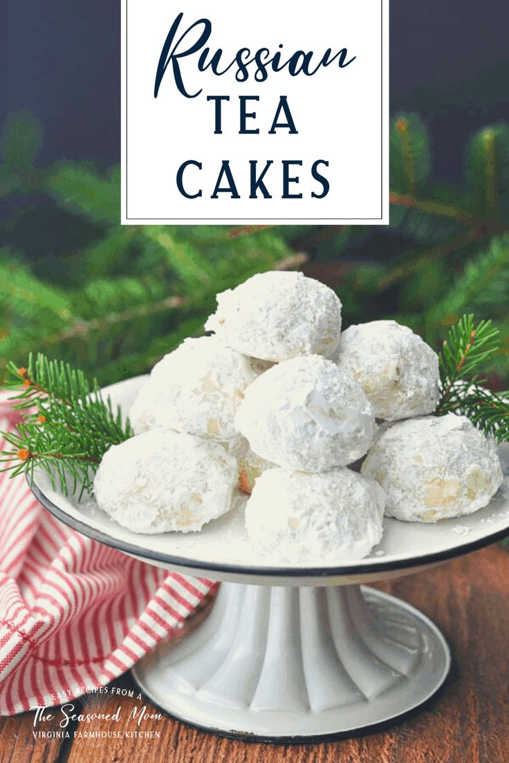 russian tea cakes on a cake plate with pine branches