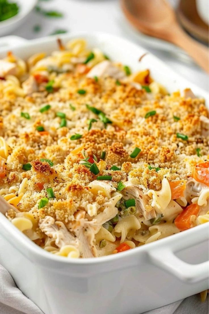 a casserole dish with chicken, noodles and vegetables