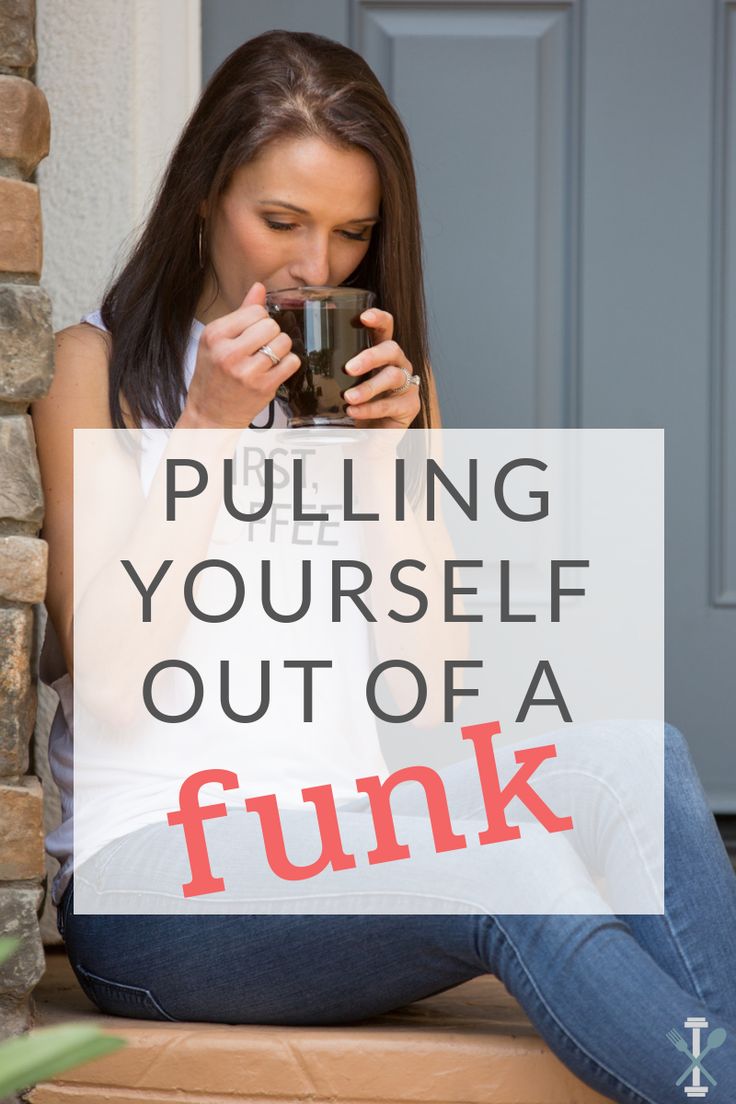 a woman sitting on the steps drinking from a cup with her hand in her mouth