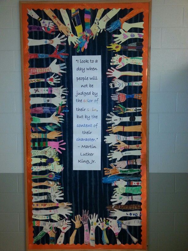 a bulletin board that has been decorated with children's handprints on it