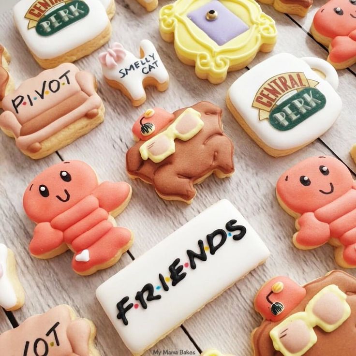 decorated cookies with the words friends written on them are displayed in front of each other