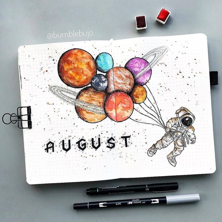 an art journal with drawings of planets and the words august written in black ink on it