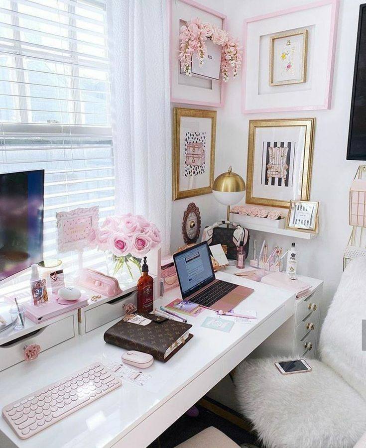 a white desk topped with a laptop computer sitting next to a window covered in pink flowers