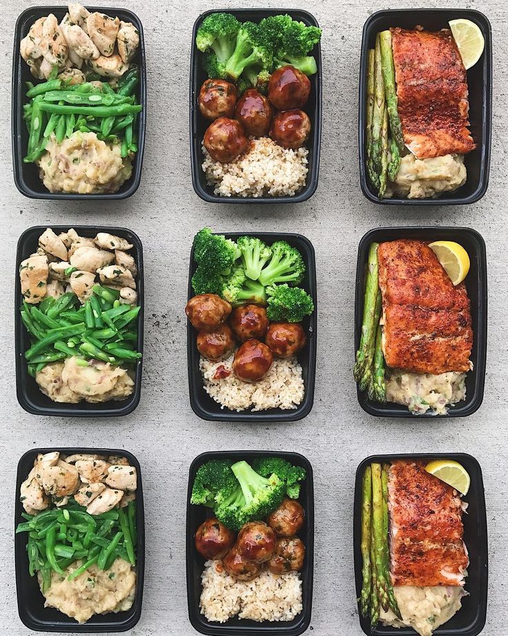 six black trays filled with different types of food on top of a white table