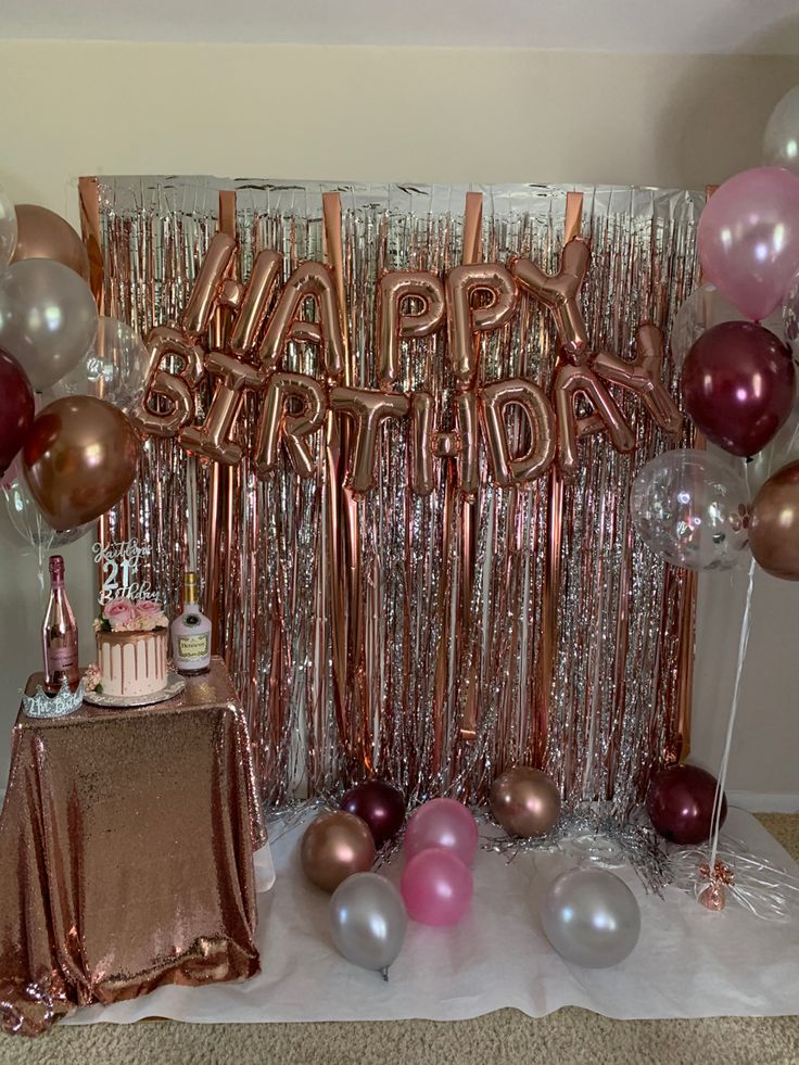 a birthday party with balloons, cake and decorations