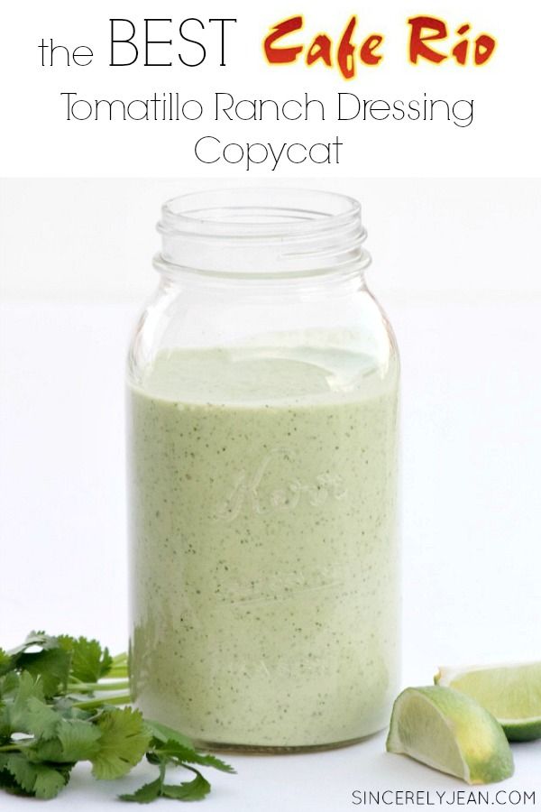 a jar filled with green liquid next to limes and cilantro on the side