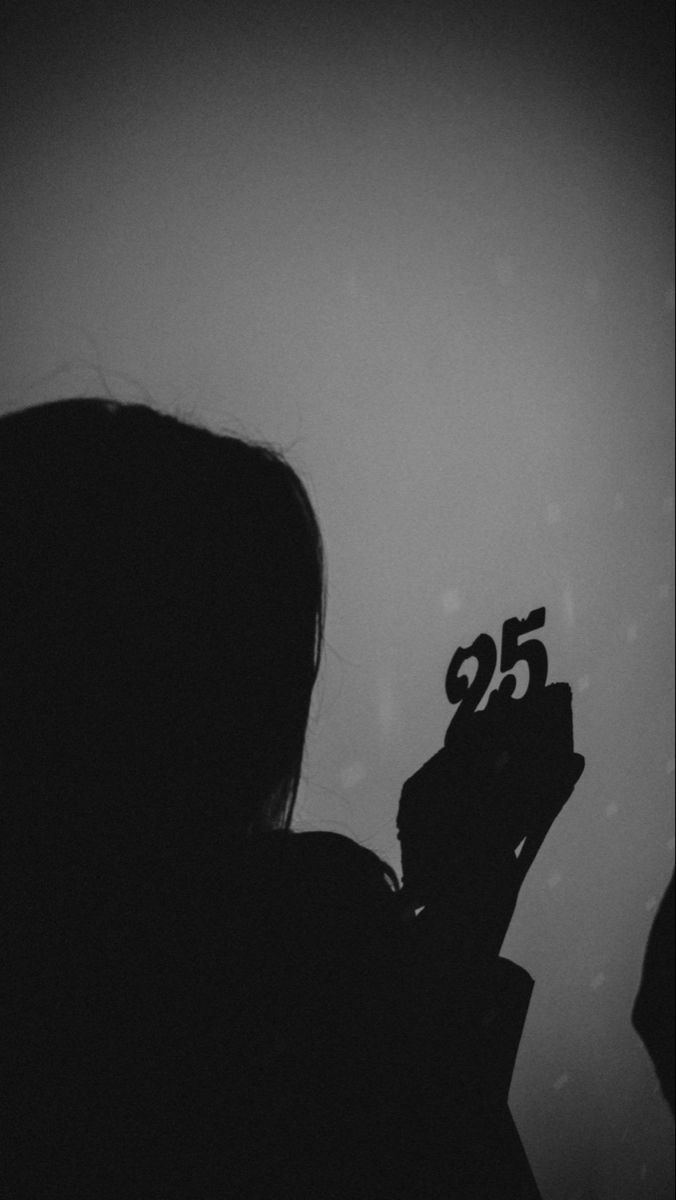 a person holding up a cell phone with the number fifty five on it's screen