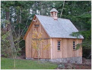 a small wooden building sitting in the middle of a forest with lots of trees around it