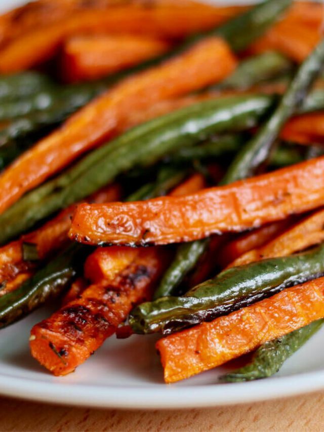 cooked carrots and green beans on a white plate