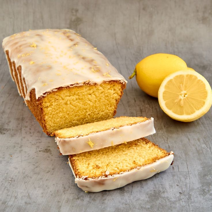 a loaf of lemon pound cake next to a sliced lemon