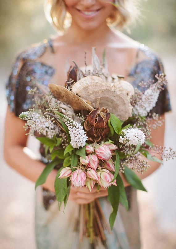 a woman holding a bouquet of flowers in her hands