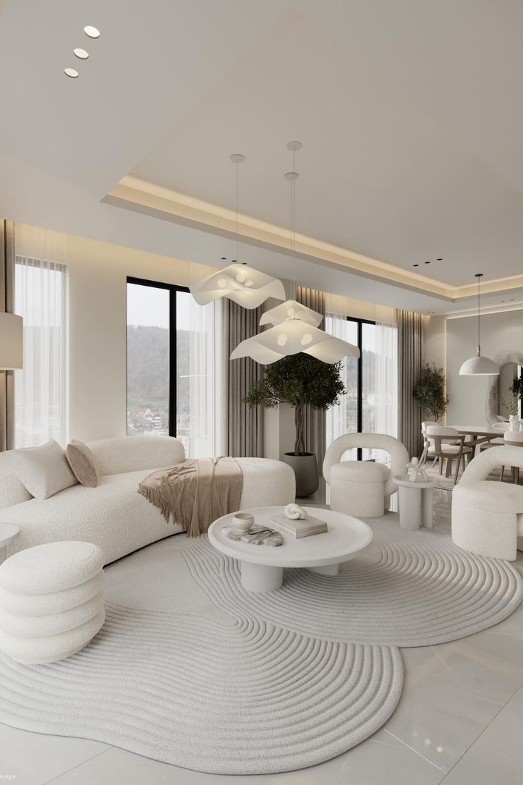 a living room with white furniture and large windows